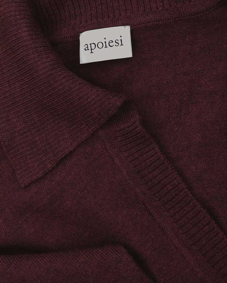 Close up of the fabric and neck label of Hekla knitted dress in burgundy